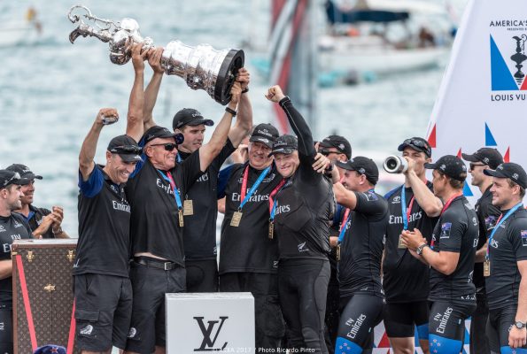 Dressed in black the New Zealand America's Cup team lift the silverware