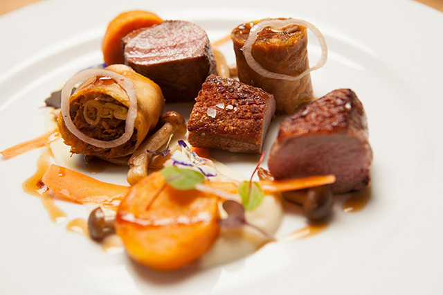 Roasted duck served on a white plate