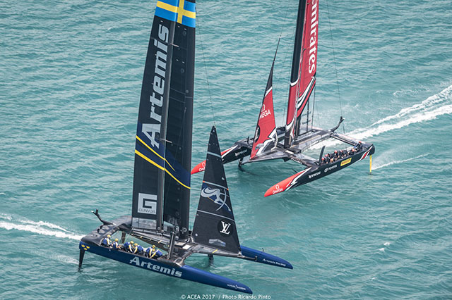 A foiling catamaran passes in front of another racing boat in Bermuda