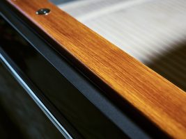 A close up of a wooden side of an electric boat by Hinckley