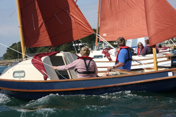 People sailing a Drascombe