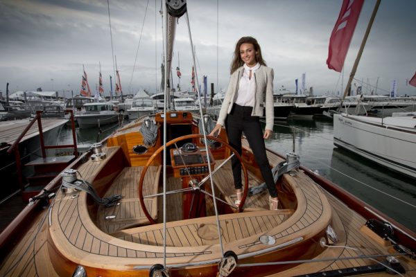 Michelle Keegan standing in a boat