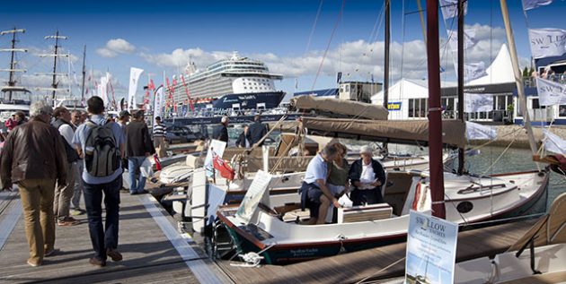 A man looking at a boat at a show