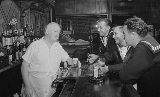 Sailors laughing a jokes in a bar