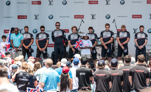 Sailors dressed in t shirts and baseball caps bow their heads to remember those killed in the terror attack in London